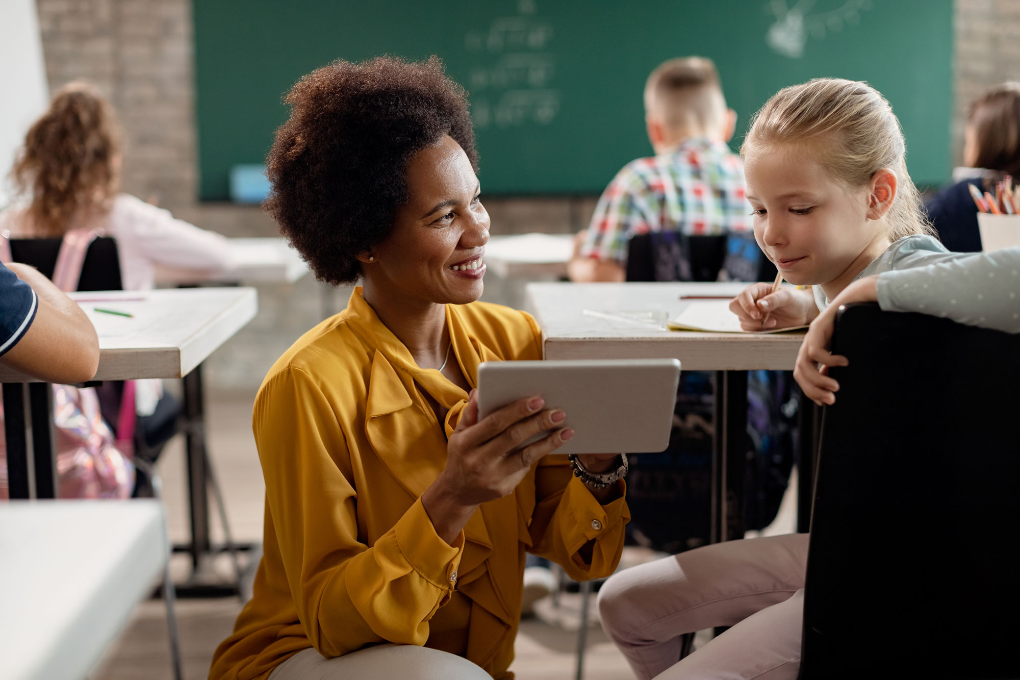 Education_Industry_Teacher_Showing_Student_Tablet