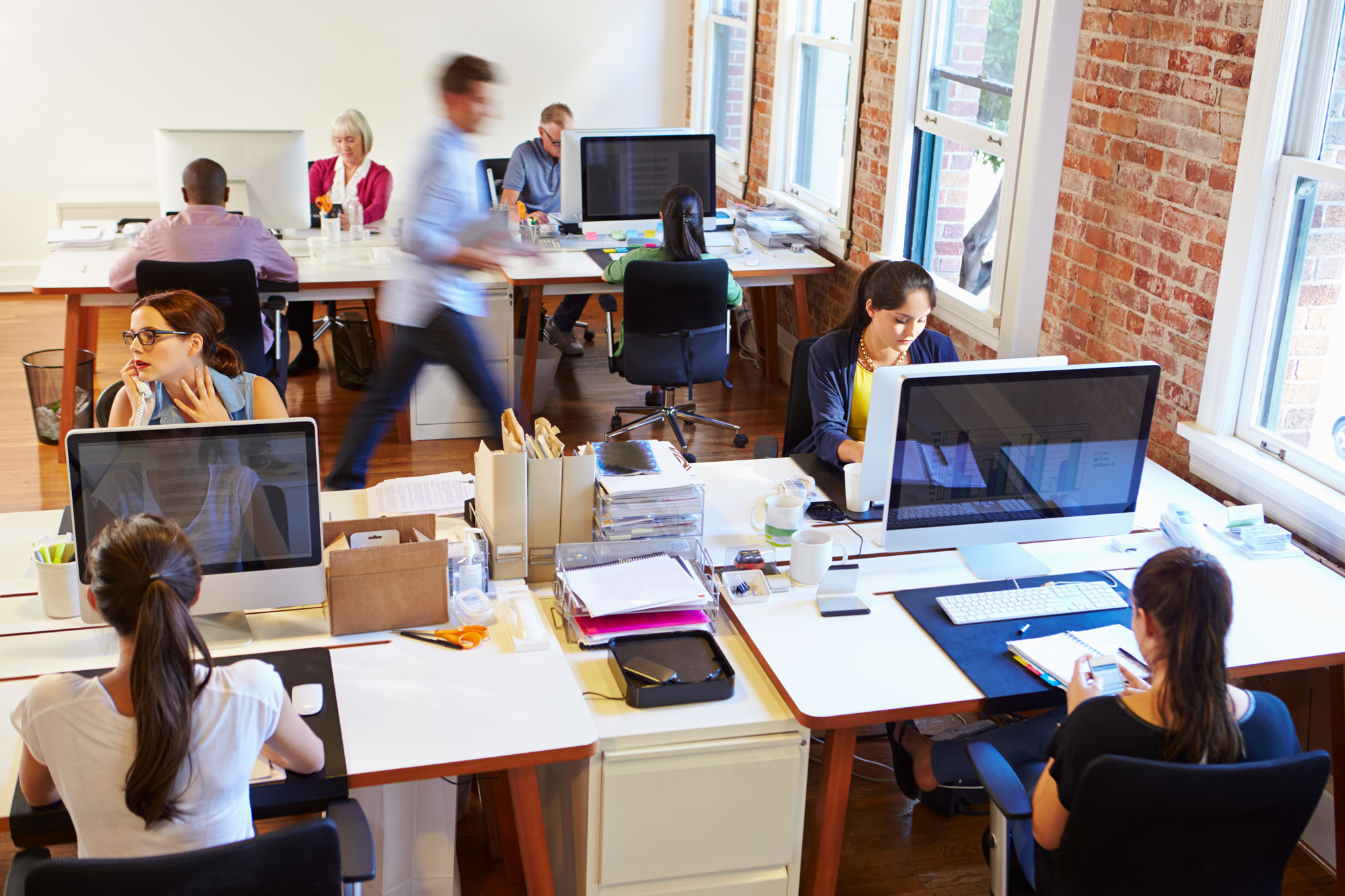 Employees working at office workstations