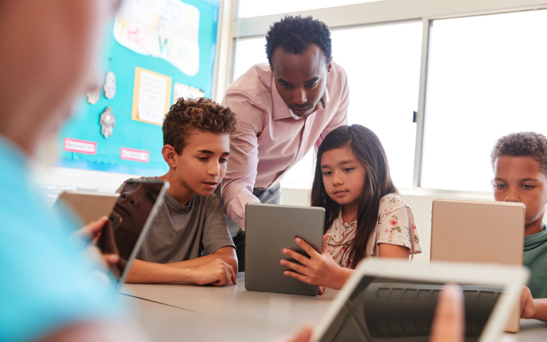 Teacher Helping Students Login To Accounts With Enterprise IAM